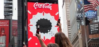 https://cdn.inavateonthenet.net/images/li/people-raise-coca-cola-bottles-in-front-of-times-square-billboard.jpg